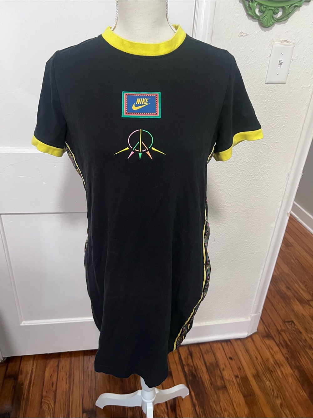 Nike Essential Black Dress with Yellow Trim and Multicolor Peace Crest Design
